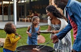 BLACK FAMILY HAVING A BBQ PARTY IMAGE